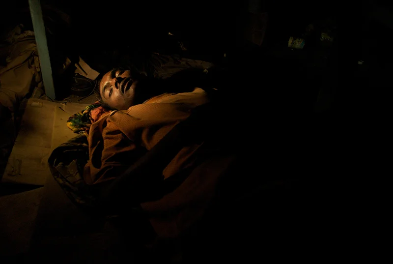 Djibouti, Djibouti, March, 2008. Fast asleep on sheets of cardboard, twenty eight year old Abas Hassan Ulusow spends the night out in the open on the rooftop of the Hanwari Shop in the centre of Djiboutiville. After fighting in Mogadishu devastated his house, Abas fled Somalia with the dream of making it to Yemen and being able to support his family.