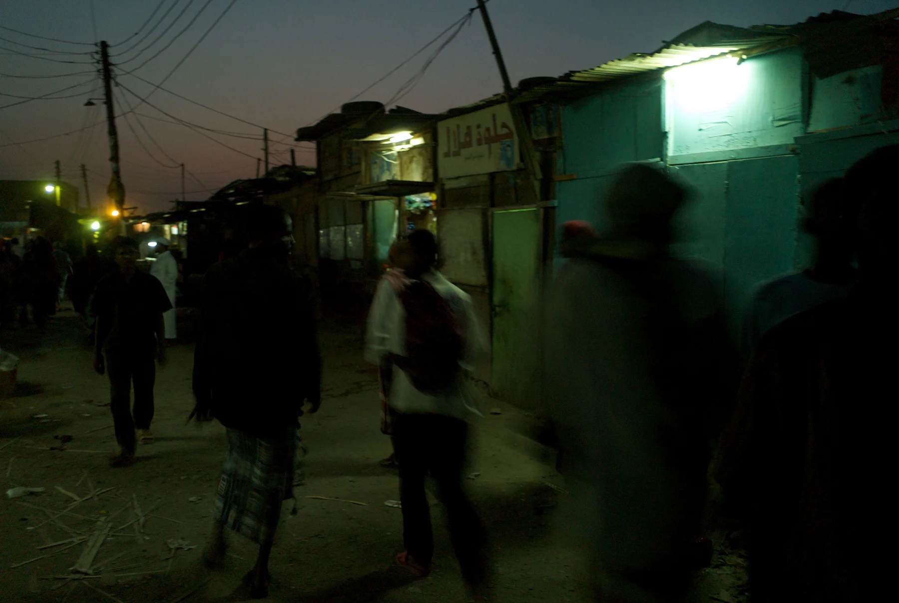 Basatine, Yemen, March, 2008. Carrying his wordly possessions in a small backpack, a newly arrived "cowboy" makes his way from the dusty bus station as he takes his first steps in the slums of Basatine.