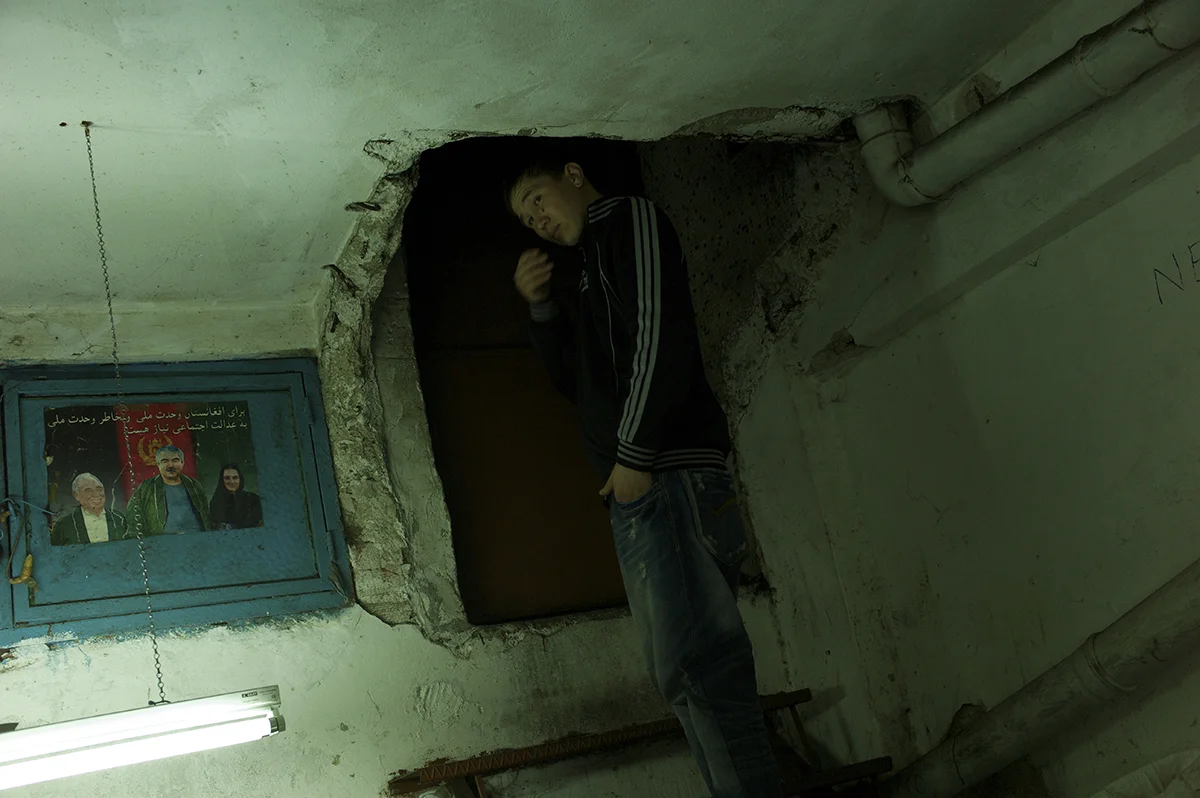 Turkey, Istanbul, January 2012, Finishing his shift at close to midnight, sixteen year old Imamuddin heads out up a metal stepladder through the carved-out entrance to the underground kargah in Zeytinburnu where he has recently found work.