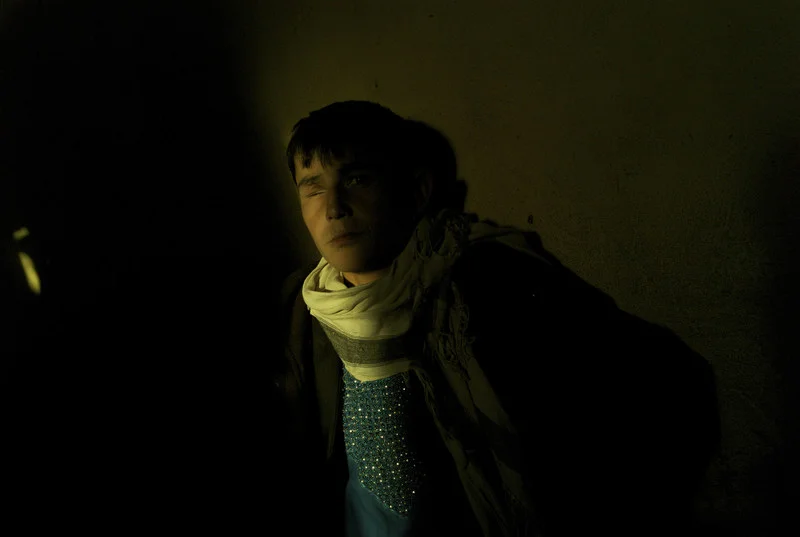 Afghanistan, Kabul, March 2012, Travelling as part of a group of six young men, sixteen year old Abdul Wased rests up against the wall in a mud built back room of a mosafer khana at the Company area bus station west of Kabul.