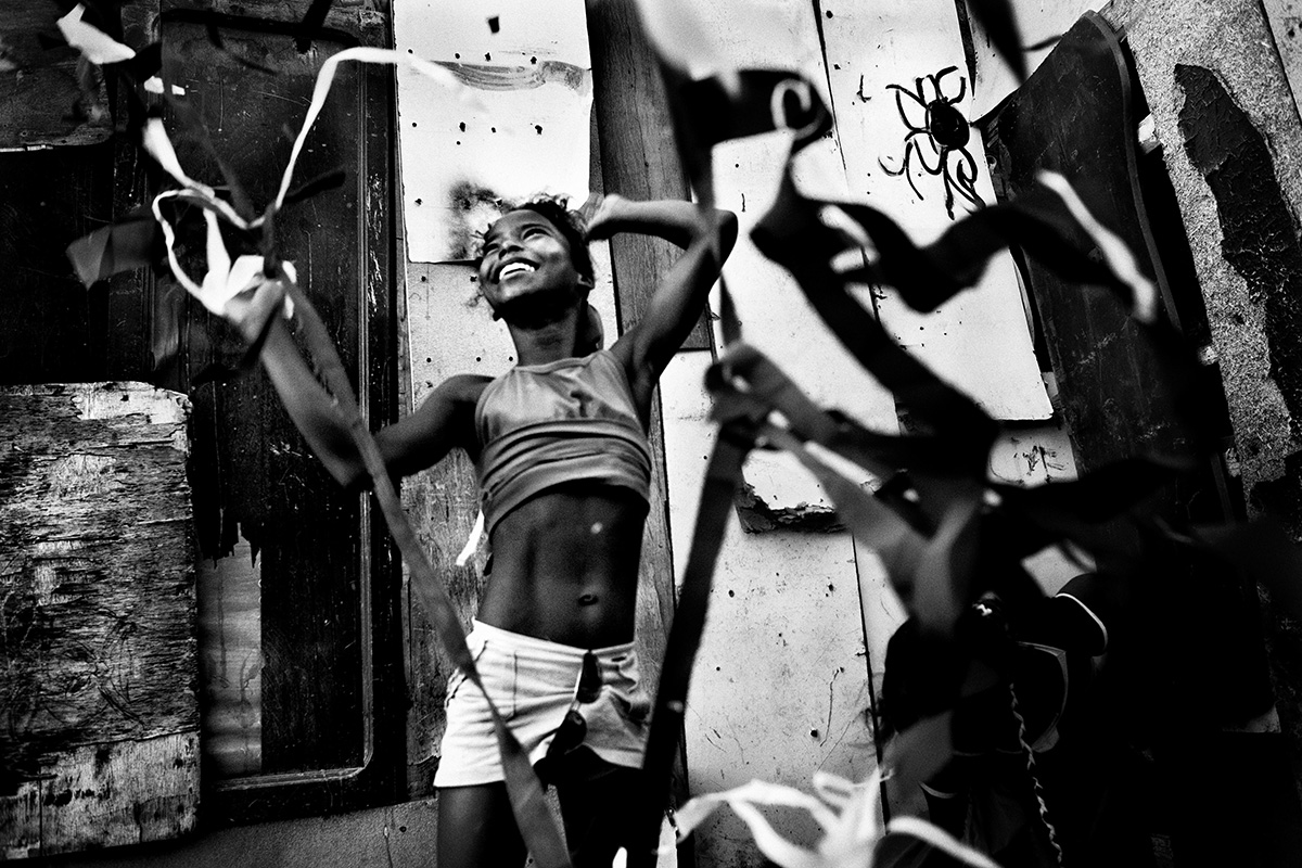 Brazil, Salvador de Bahia, December 2009, Selenia (12) dancing and playing with pieces of clothes from the garbage.