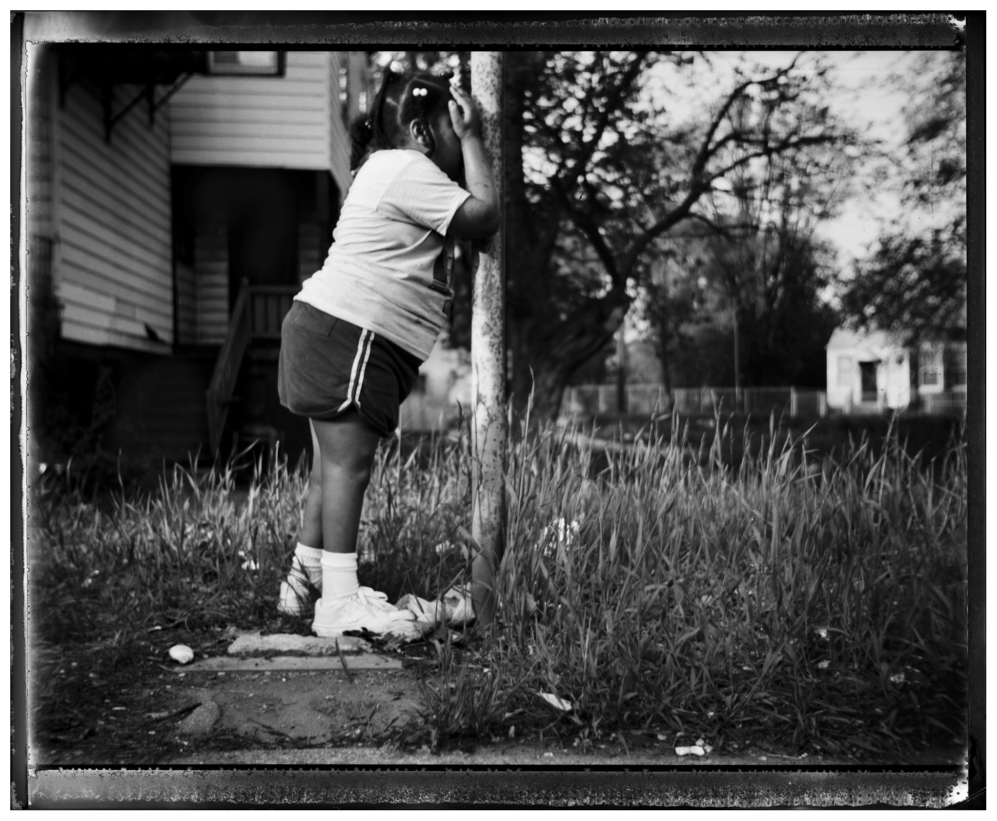  Mariah Driver plays Hide and Seek with her sisters outside her house on S. Chicago St. in Chicago's Pocket Town neighborhood. The family has since moved to the Englewood neighborhoodand the house, which was in decrepit condition, has been demolished