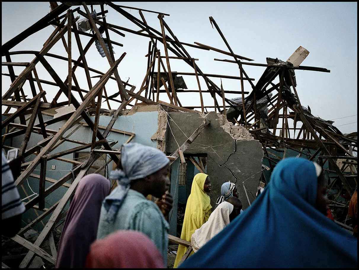 Nigeria, Mando, December 2011, Young girls look at the damage caused by the explosion of homemade bomb, kept in a private house.