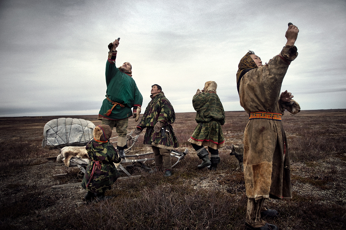   Russia, Yamal, October 2009,&nbsp;The Nenets family tries to find connection for their mobile phones.  