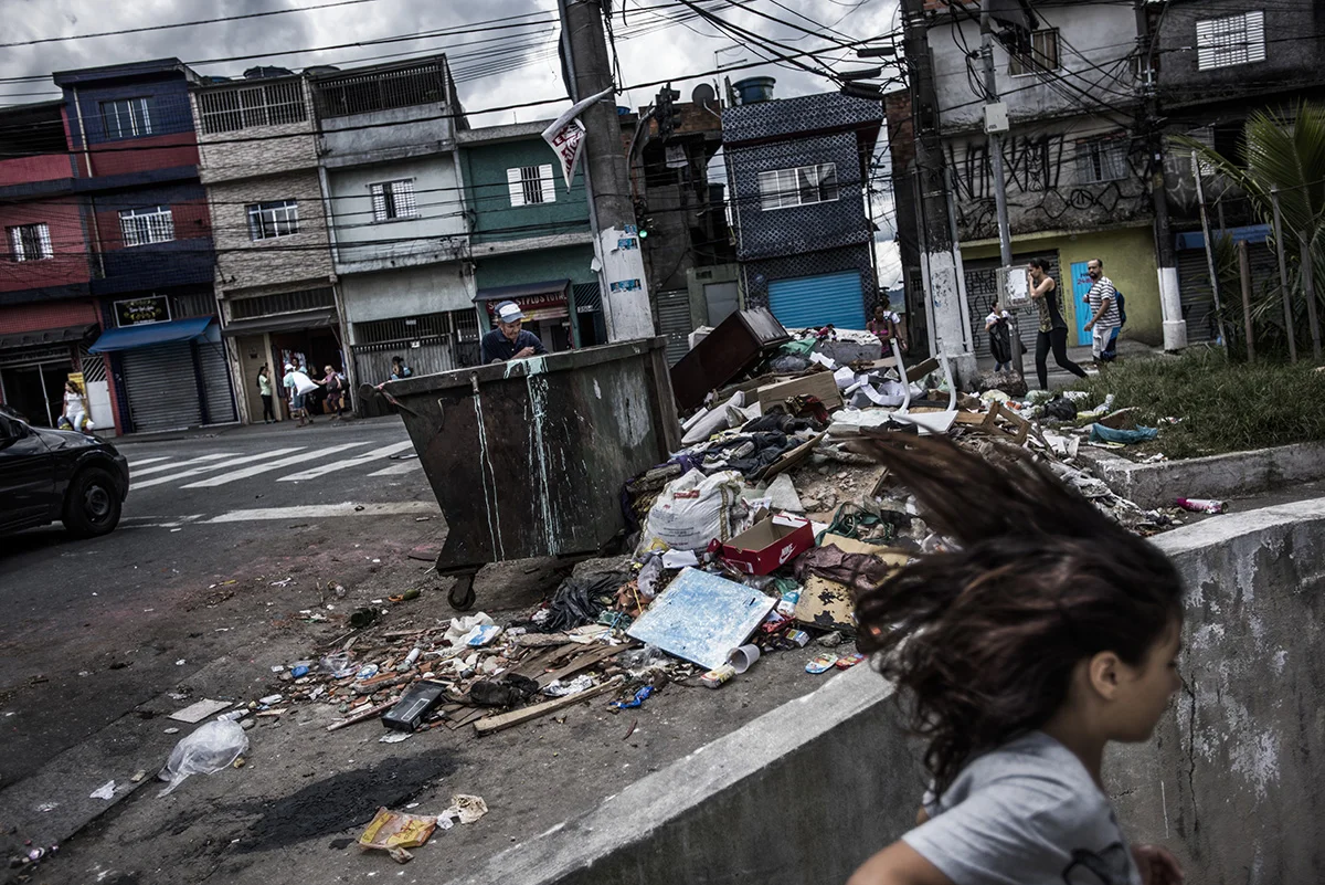 Brazil, São Paulo, December 2016, Waste on the streets at containers, which are infrequently emptied.