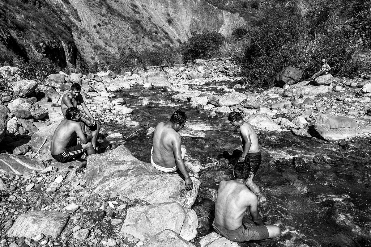 Peru, Andes, August 2016, Porters and cooks having bath at Quebrada Yurahayo, a stop in the route from Choquequirao to Maizal Camp.