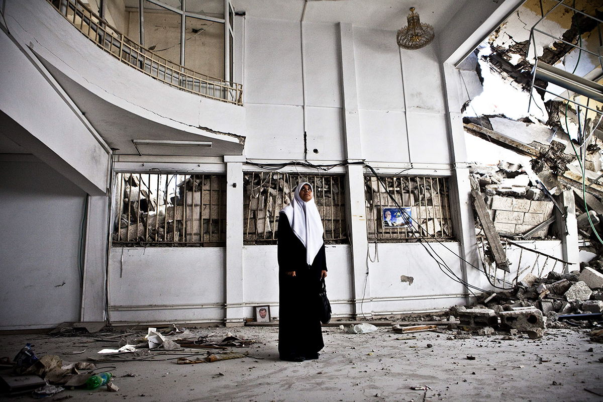   Occupied Palestinian Territories, Gaza City, October 2009, Huda Naim (a member of the Palestinian Legislative Council and Secretary of the Hamas Bloc) examines the damage to a government building after 2008-09 Israeli Cast Lead assault.  