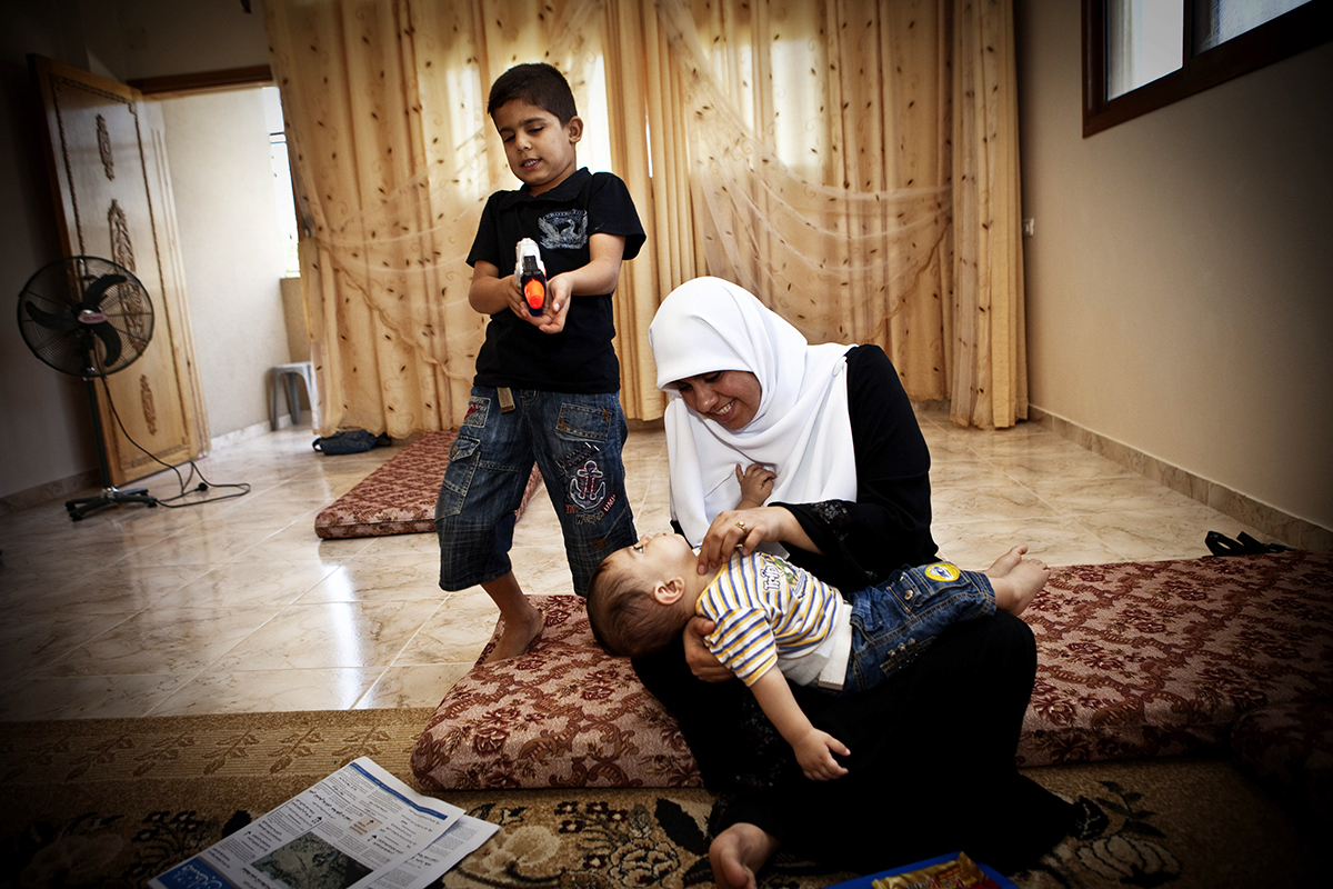   Occupied Palestinian Territories, Gaza City, October 2009, Huda Nae'm, a Hamas lawmaker in Gaza, plays at home with her children.  
