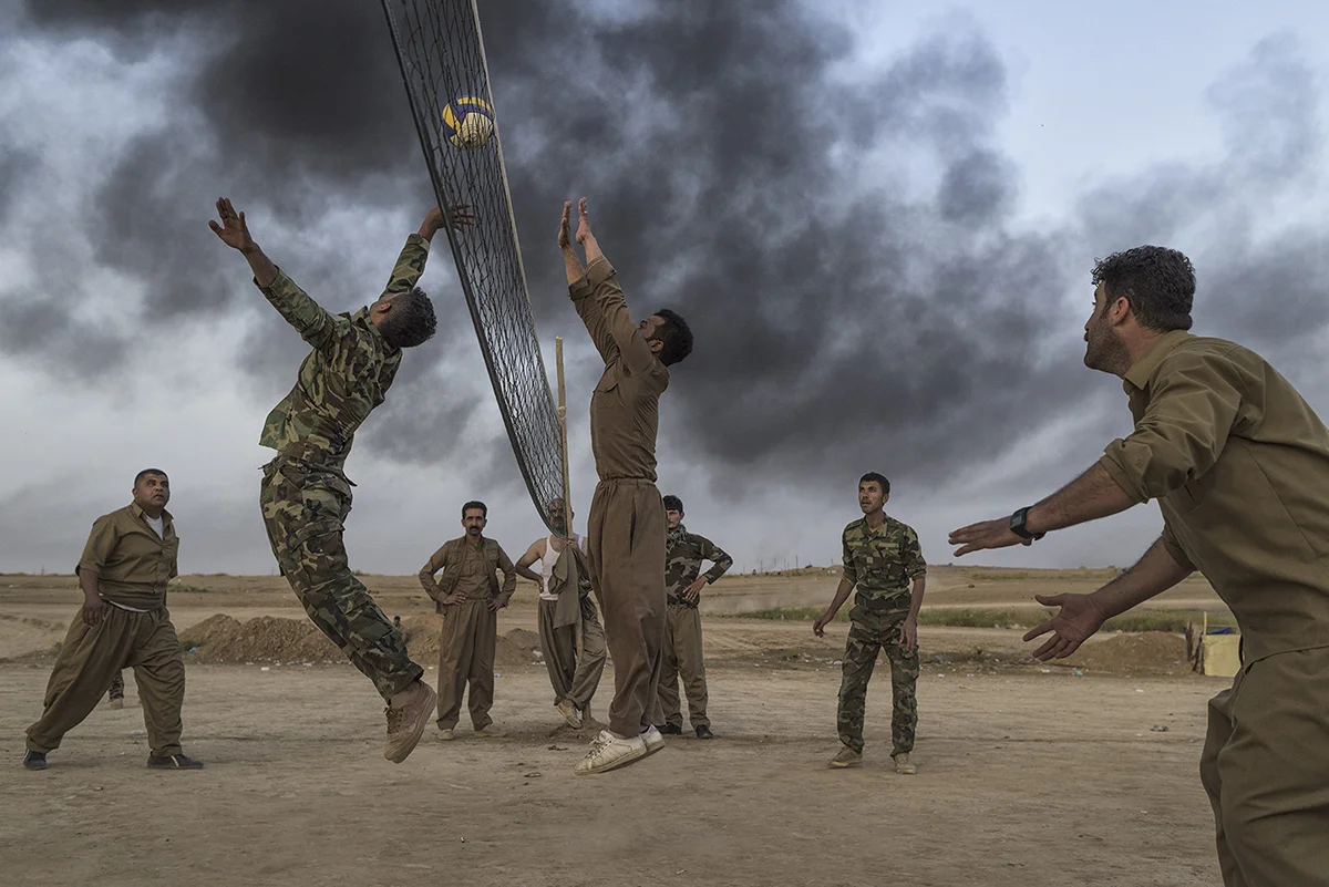 Iraqi Kurdistan, Kirkuk, April 2015, Kurdish troops called Peshmerga play volleyball behind the front lines. When ISIS fighters, whose ranks are believed to include former Iraqi Army officers, began capturing Iraqi towns in 2014, the peshmerga proved one of the only forces able to stop them.