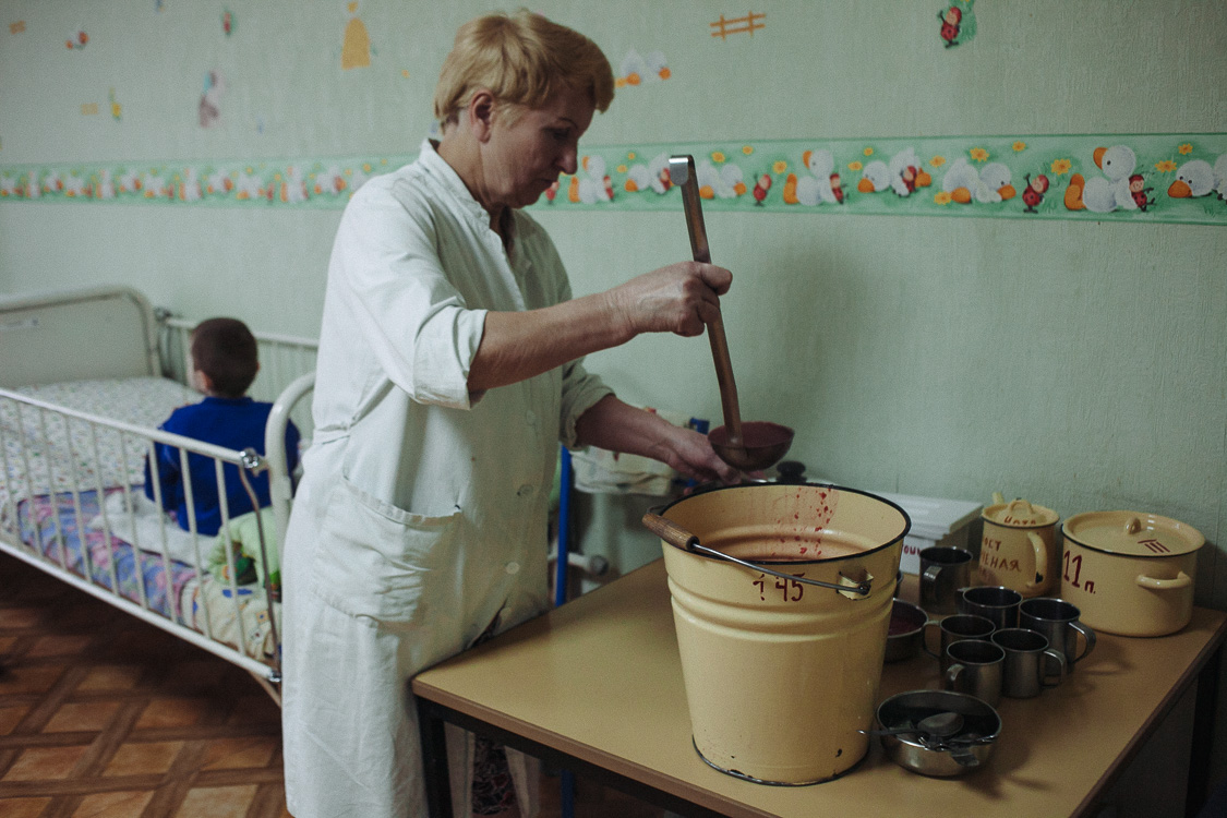  Nurse of the orphanage for disabled children with special psychophysical development is serving food for children. October 10, 2016, Minsk, Belarus.

According to the norms, every child of this age is supposed to eat 700 grams of food for lunch. The