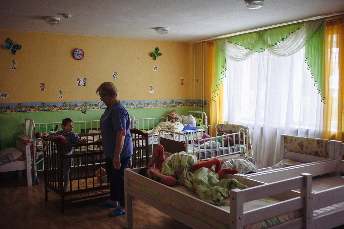  Nurse communicates with one of the children that lives  in the orphanage for disabled children with special psychophysical development. October 10, 2016, Minsk, Belarus.

Most of the time in the orphanage, the children are alone with themselves. At 