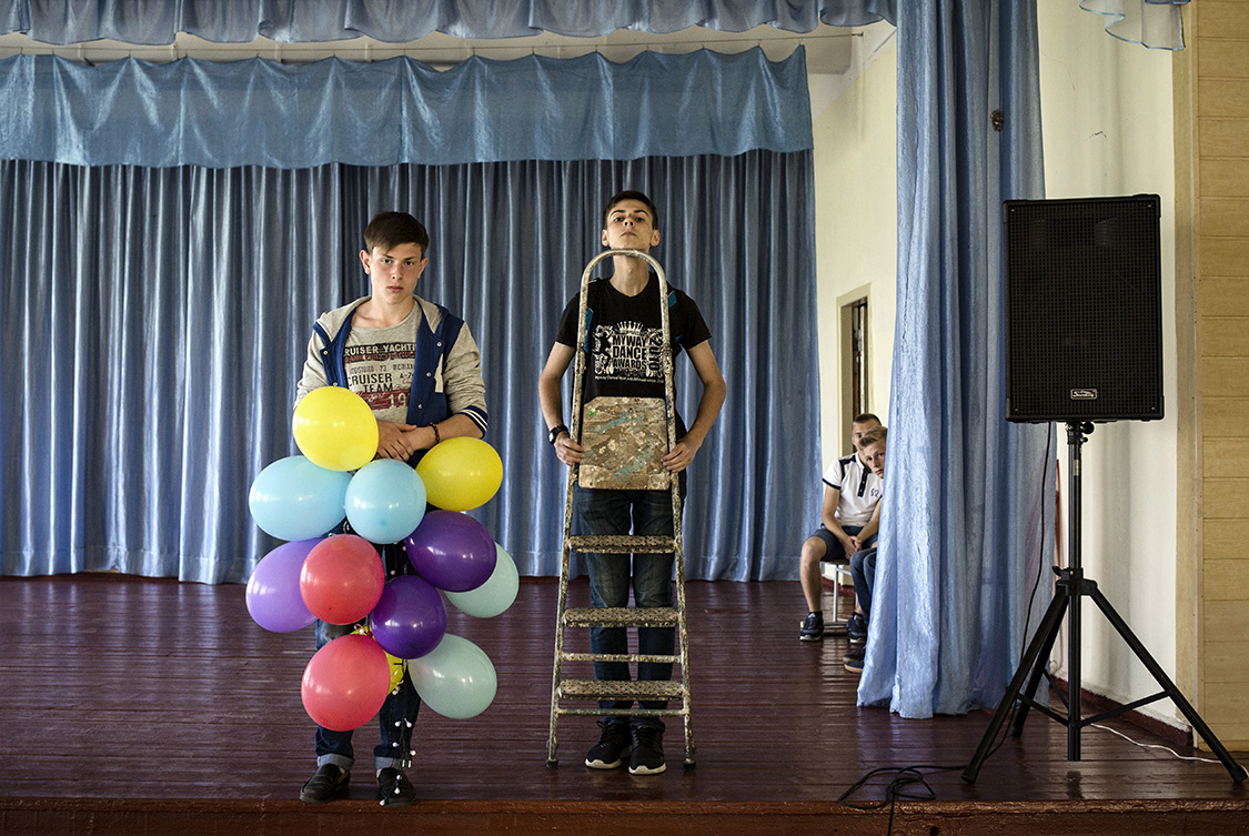  Classmates, Ilya Gudzovatiy and Ilya Shlykov, decorate the school's assembly hall in Shchastya, Luhansk area, Ukraine. 
Shchastya is a small provincial town in some 10 km from the front line.  