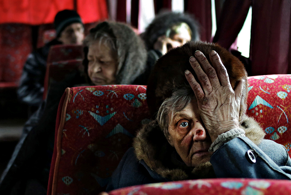  - Is there a blood in my face? 

A woman who was just evacuated from an embattled town of Debaltseve, sits in a bus. 
