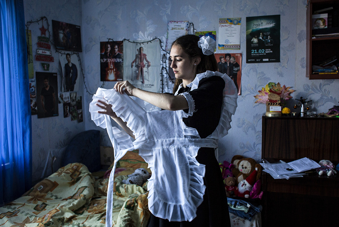  Anastasia Sarancha, 17, gets dressed for her graduation day in Shchastya, Ukraine.
Anastasia, as most of the young people in town, doesn't see her future in Shchastya and dreams to leave for a bigger town outside the war zone. 