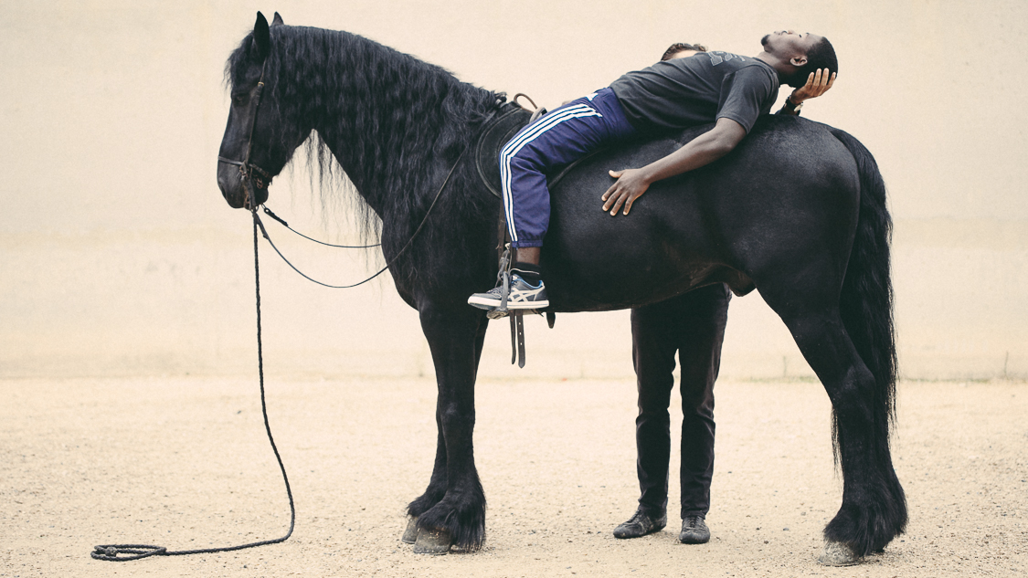  France, Marseille, 30 september 2014.

The inmate is lying on the horse to learn to completely let his fears and trust the animal.

Francesca Todde / NOOR 