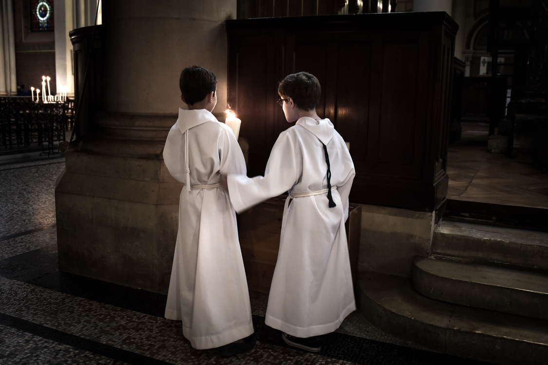  Two young children participate at the sunday mass at Saint-Ambroise's church. 