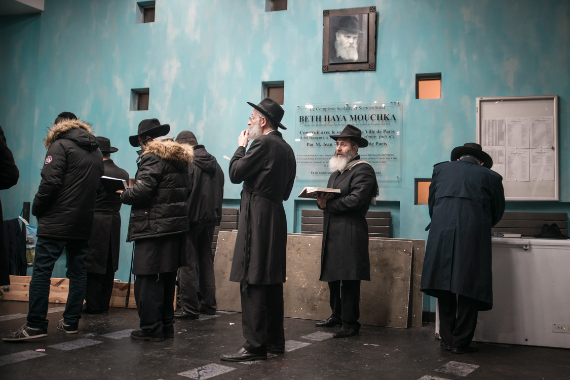  While men are praying in the hall of the Beth Haya Mouchka, facing Jerusalem, a portrait of the rabbi Mendel Schneerson is seen on the wall. He was considered as the messia by a large part of the Jewish community. 