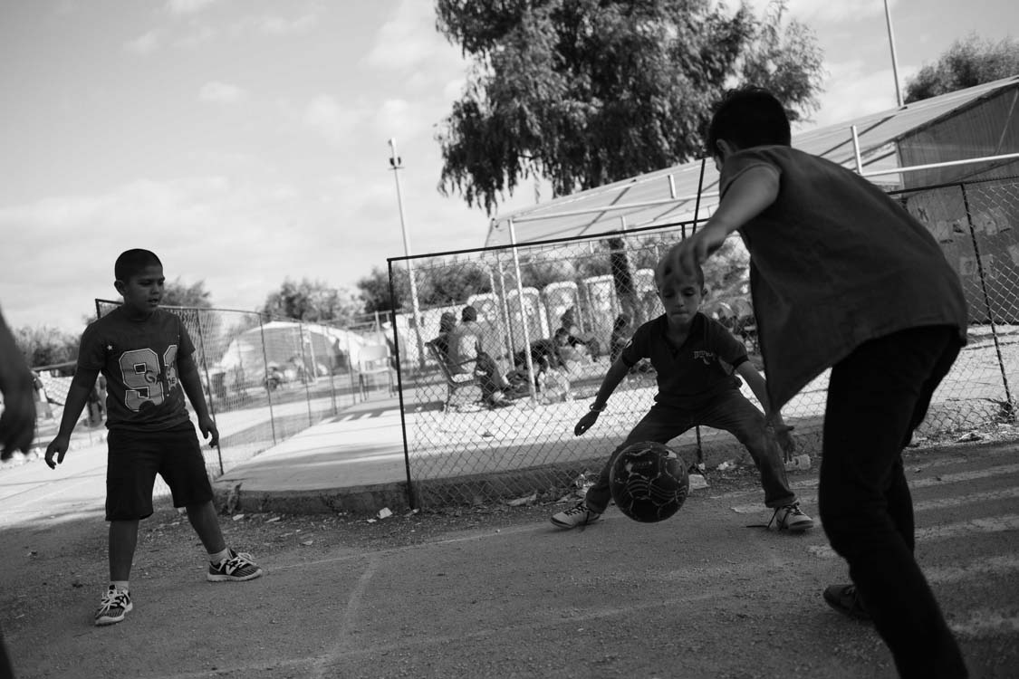  Syrian refugees play football inside Kara Tepe camp, Lesbos, Greece. The camp is for Syrian refugees. 