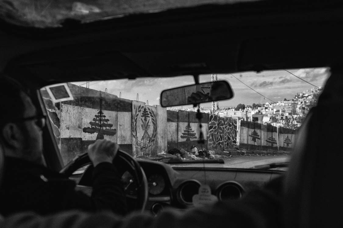  Driving around the security wall of Ain el Hilweh, refugee camp in Lebanon. 