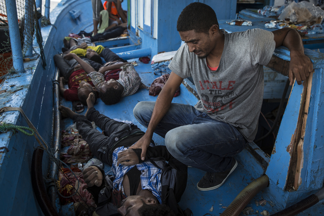  A migrant grieves over the death of his brother. 4 lifeless bodies were recovered by the migrants from separate holds. � Mathieu Willcocks/MOAS.eu 2016, all rights reserved. 