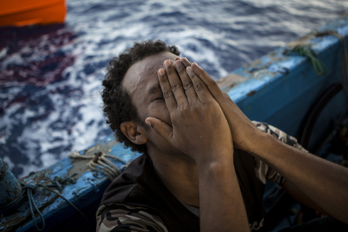 A migrant grieves over the death of his brother. 4 lifeless bodies were recovered by the migrants from separate holds. � Mathieu Willcocks/MOAS.eu 2016, all rights reserved. 