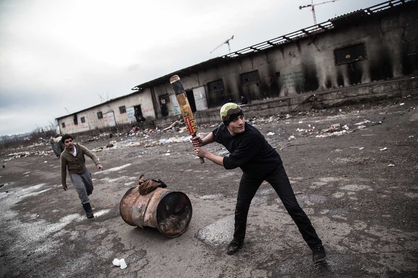  Refugees play cricket in one of the former loading bays of the "barracks", once an industrial complex, now a makeshift camp, in Beblgrade, Serbia, where almost 1,300 refugees are sleeping rough. 
 