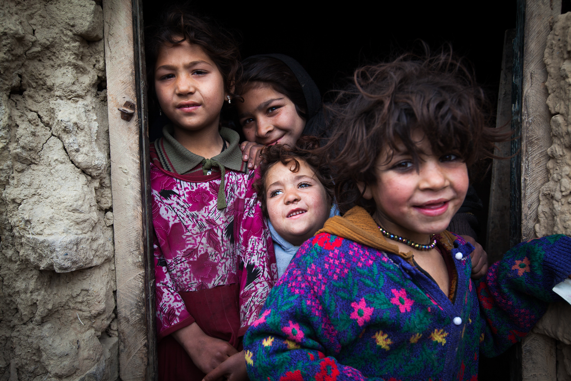  Children wander around barefoot in the in the extremely harsh winter conditions yet still smiling and playing with each other. 