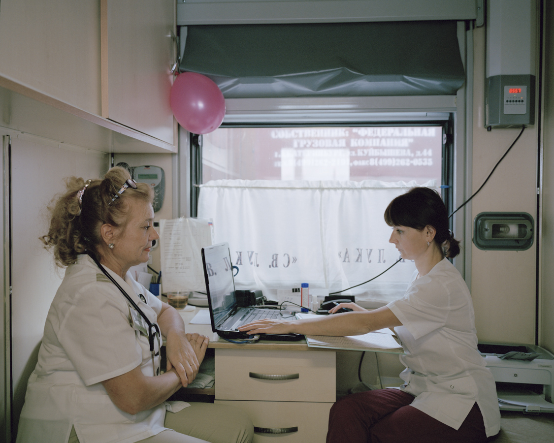  The therapist Danilova Lyudmila
Mikhailovna (l.) and her
assistant analyse the data of
their diagnoses in a narrow
compartment. Every day they
are supposed to check around
37 patients.

Kuragino, Krasnoyarsk Krai,
Russia,
13.11.2016. 
