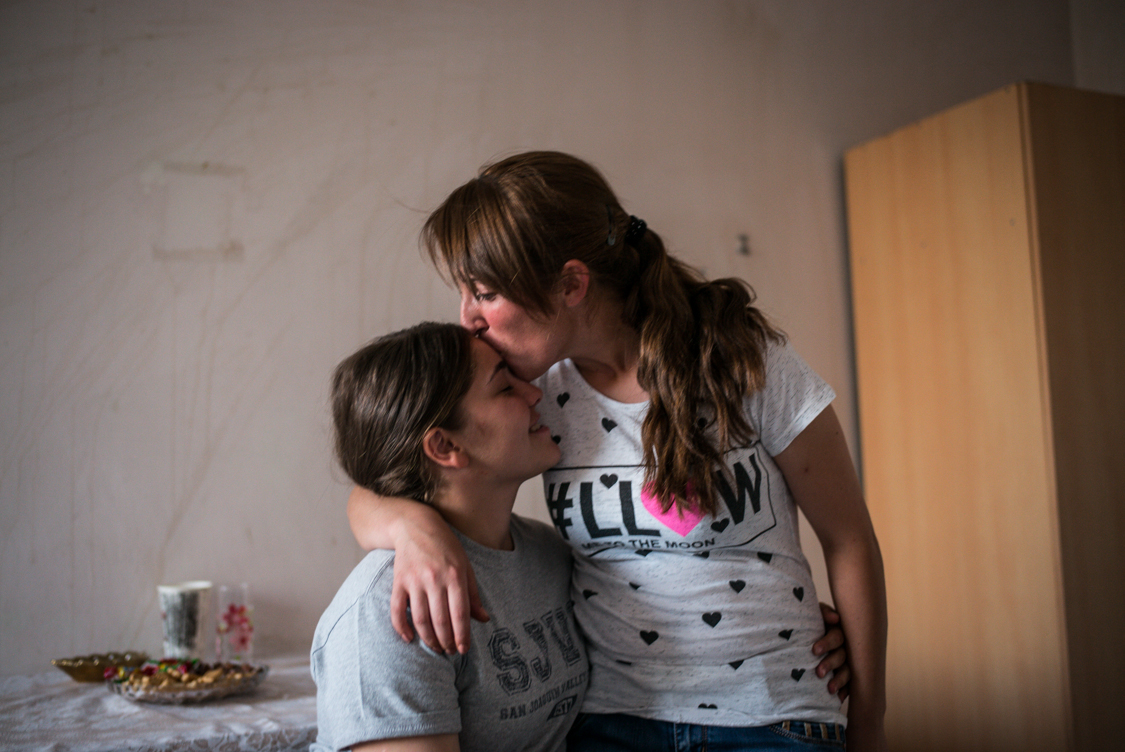  Two girls hugging each other in their private room in the dormitory, Yerevan 