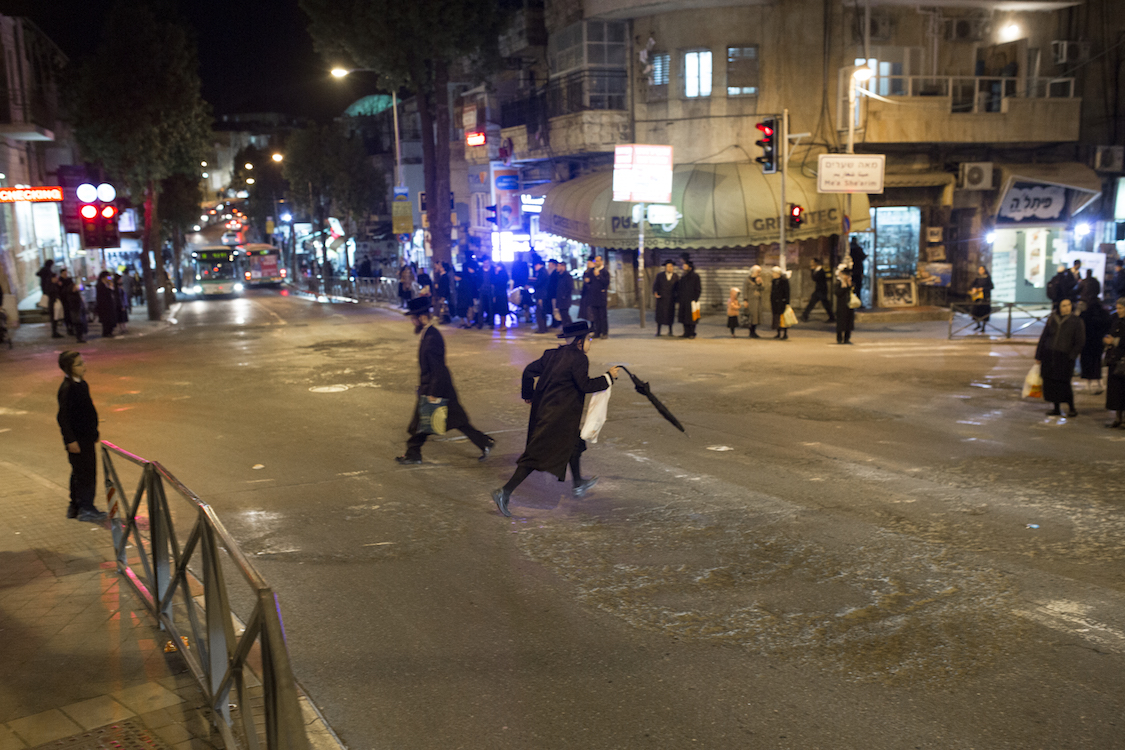  A young Ultra Orthodox Haredi runs over the main cross that connects the big Ultra Orthodox neighbourhoods like Meah Shearim, in the heart of Jerusalem on 9th January, 2016. Most of the Ultra Orthodox Areas are divided between the main Family tribes