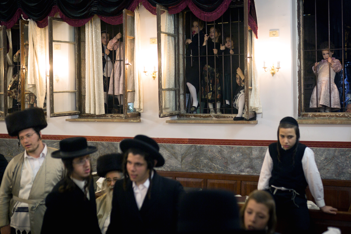  Young Ultra Orthodox girls watching the Simhat Torah celebrations from outside of windows in Jerusalem's Mea Shearim neighbourhood on October 24, 2016. Jews marking the end of the annual cycle of the reading of the Torah and the beginning of the nex