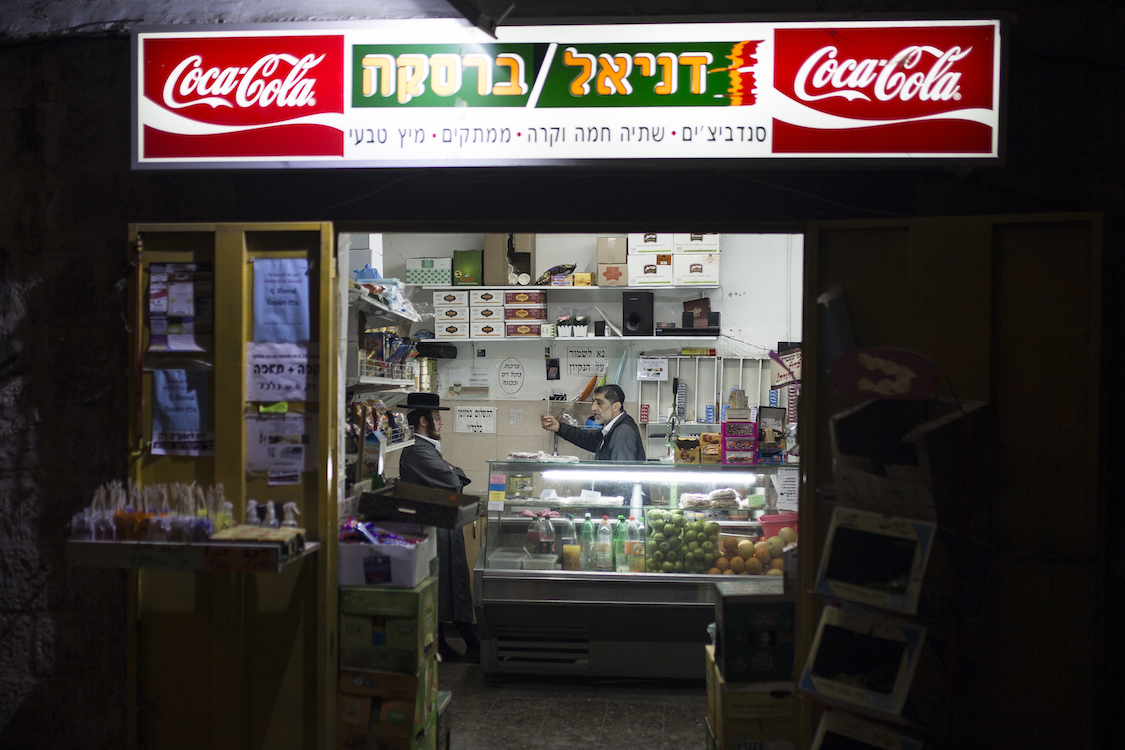  Two Ultra Orthodox Haredim seen chatting in a small supermarket in the Ultra Orthodox neighbourhood of Meah Shearim, Jerusalem on Januar 9th, 2016. The Haredim are relatively materially poor, compared to other Israelis, but represent an important ma