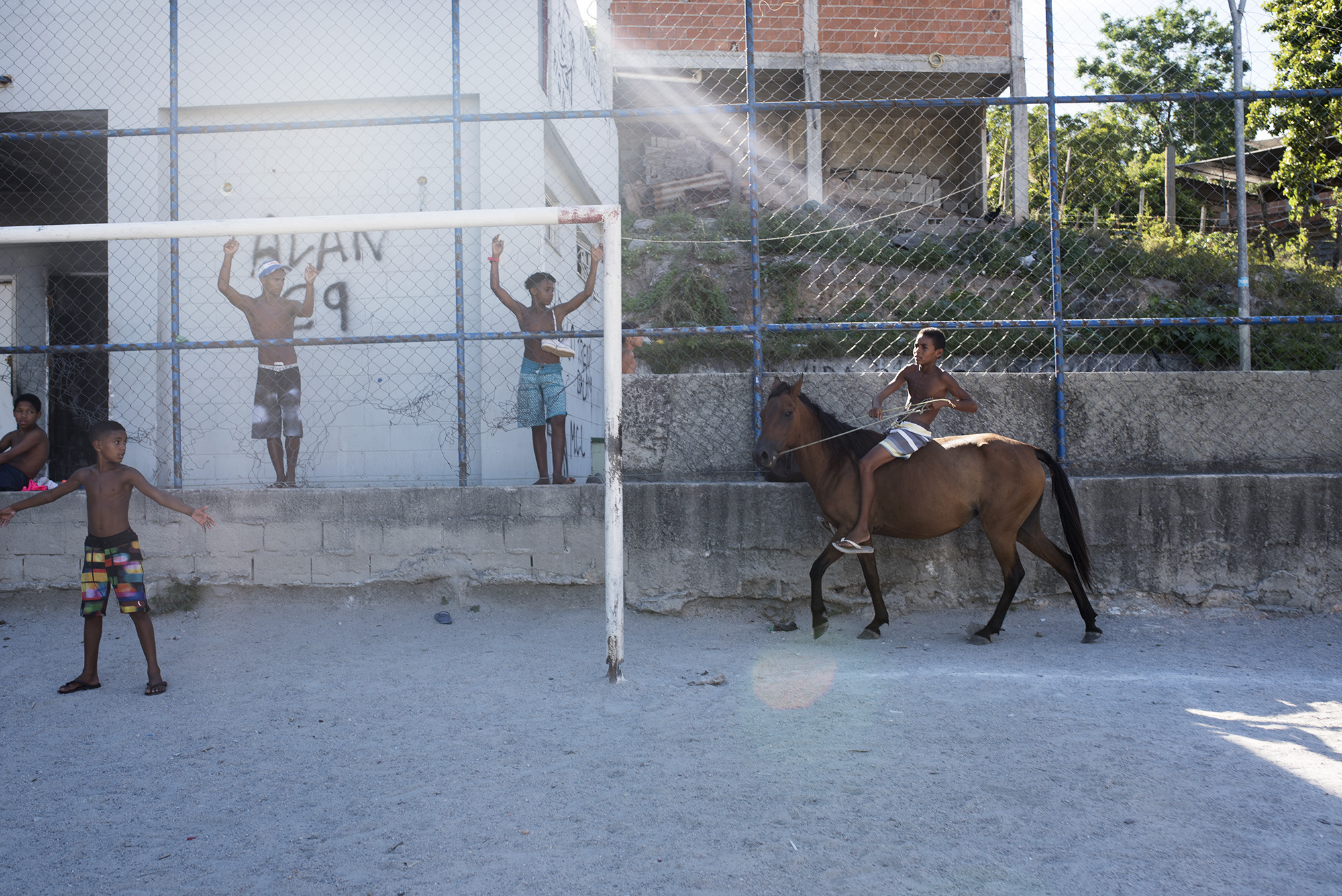  The kids are waiting for Fabio to give his weekly football training. In the meanwhile they’re horseback riding around the field of Vacaria. Vacaria is the most deprived and dangerous area of Vila Cruzeiro.  