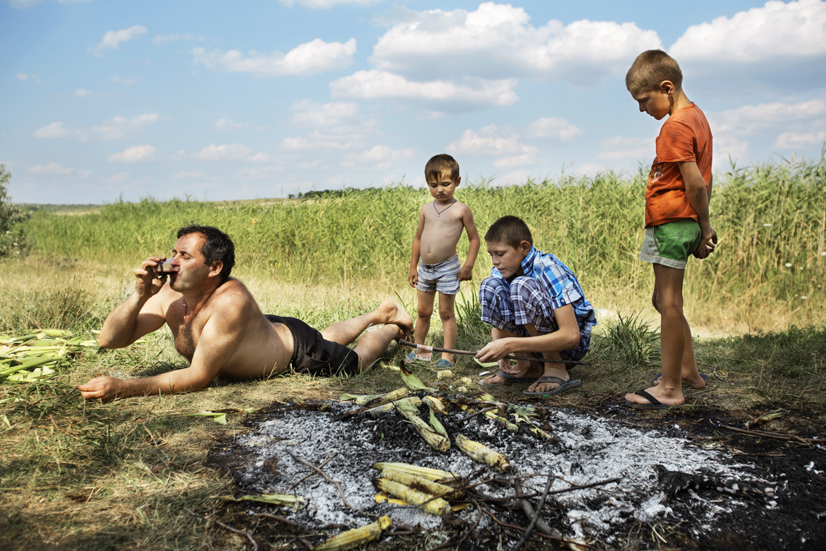  Moldova. Beshalma, Gagauzia - July 2017

Vadim while dries up banknotes after a bath at the lake. On holiday days, men and kids often go to the field to play and spend moments of relax. 