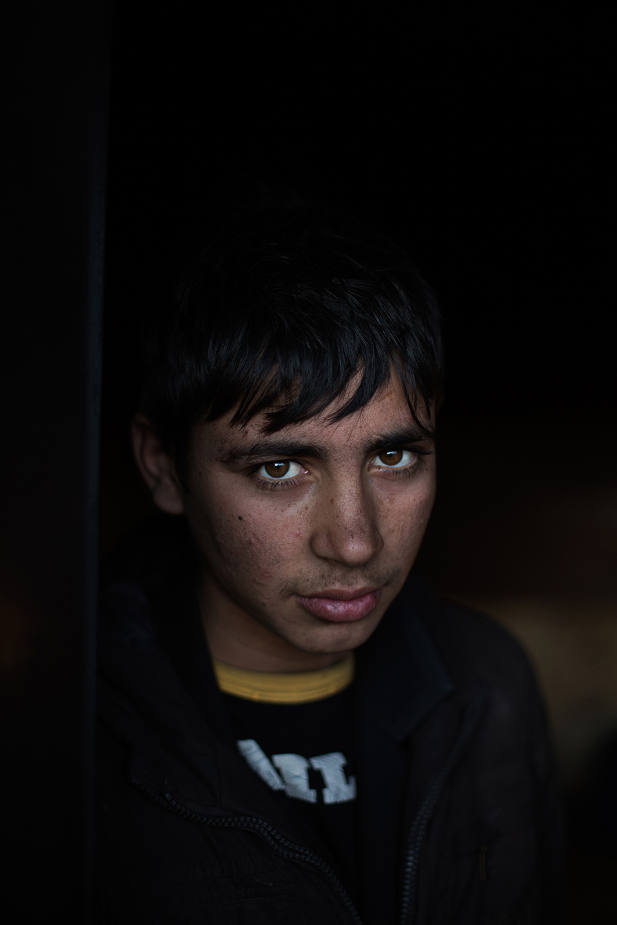  14 year-old Melet, an Afghan refugee sleeping rough in an abandoned warehouse behind Belgrade’s main train station. Belgrade, Serbia. January 2017. 
