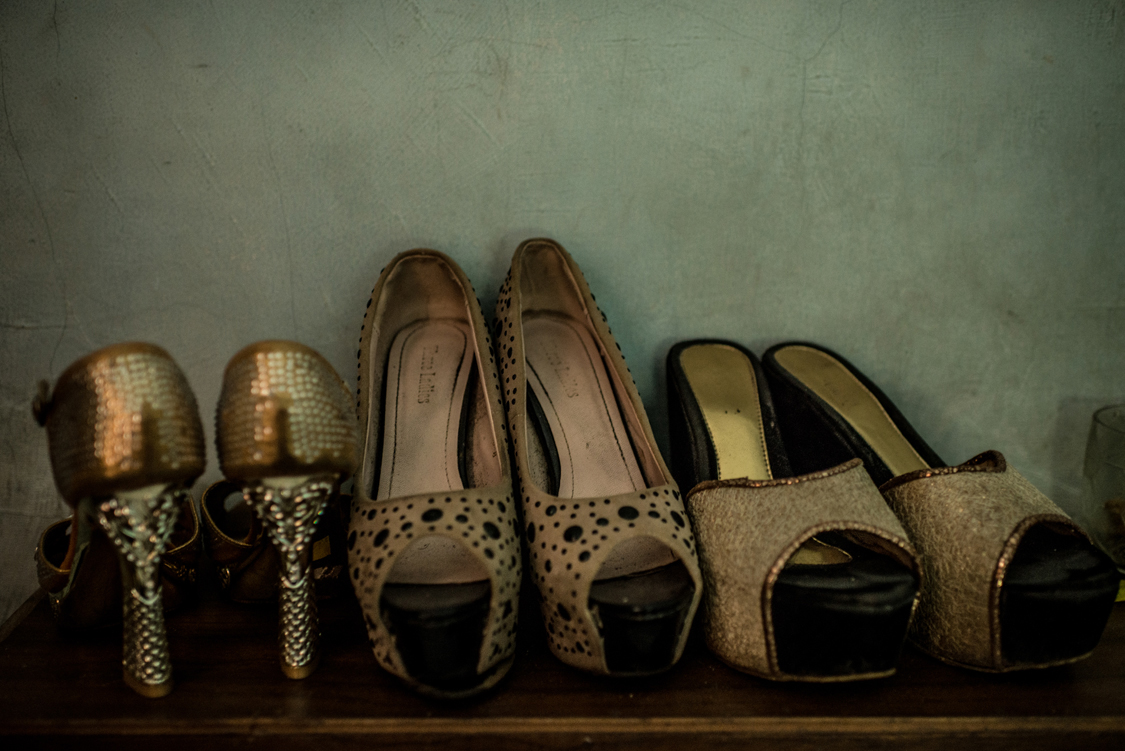  The golden high heels shoes of a young waria, street sex worker, are well sorted on the shelf in her tiny rental room. Jakarta, Indonesia, 23rd February 2017 