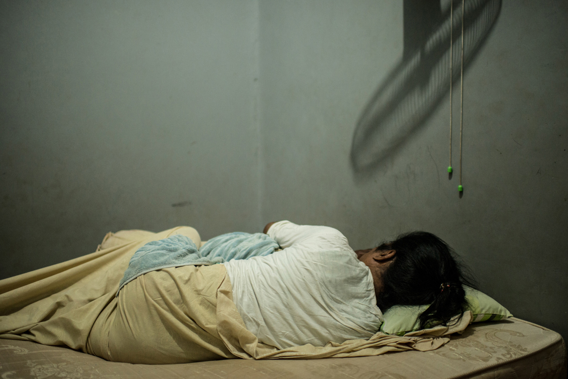  Mami Yuli, aka Yulianus Rettoblaut, born 1961, sleeps in her room in the shelter house for elderly waria. She is the leader of Indonesian waria, an “umbrella” word, that stands for transgender and transvestite people.  Jakarta, Indonesia, 8th June 2
