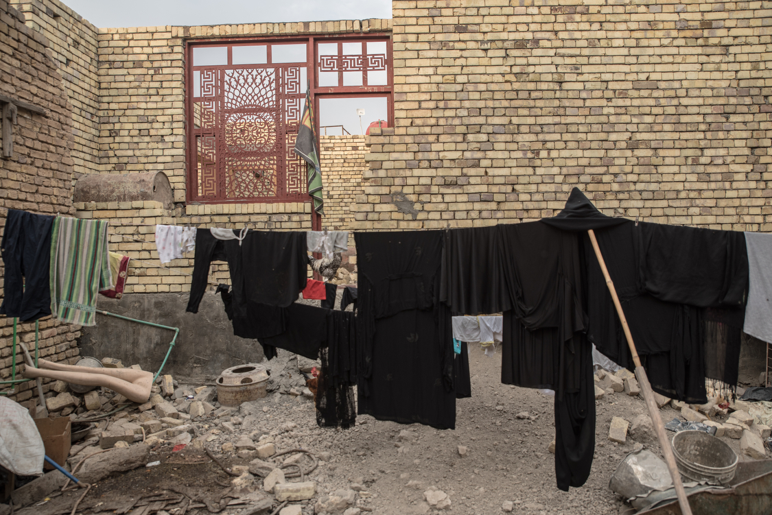  Black clothes hang in front of the family's house. During the month of Muharram, which symbolizes the mourning of Imam Hussein's death, Shiite muslims only wear black. In very conservative Chibayish, women wear black abayas all year round. 
Iraq, 16