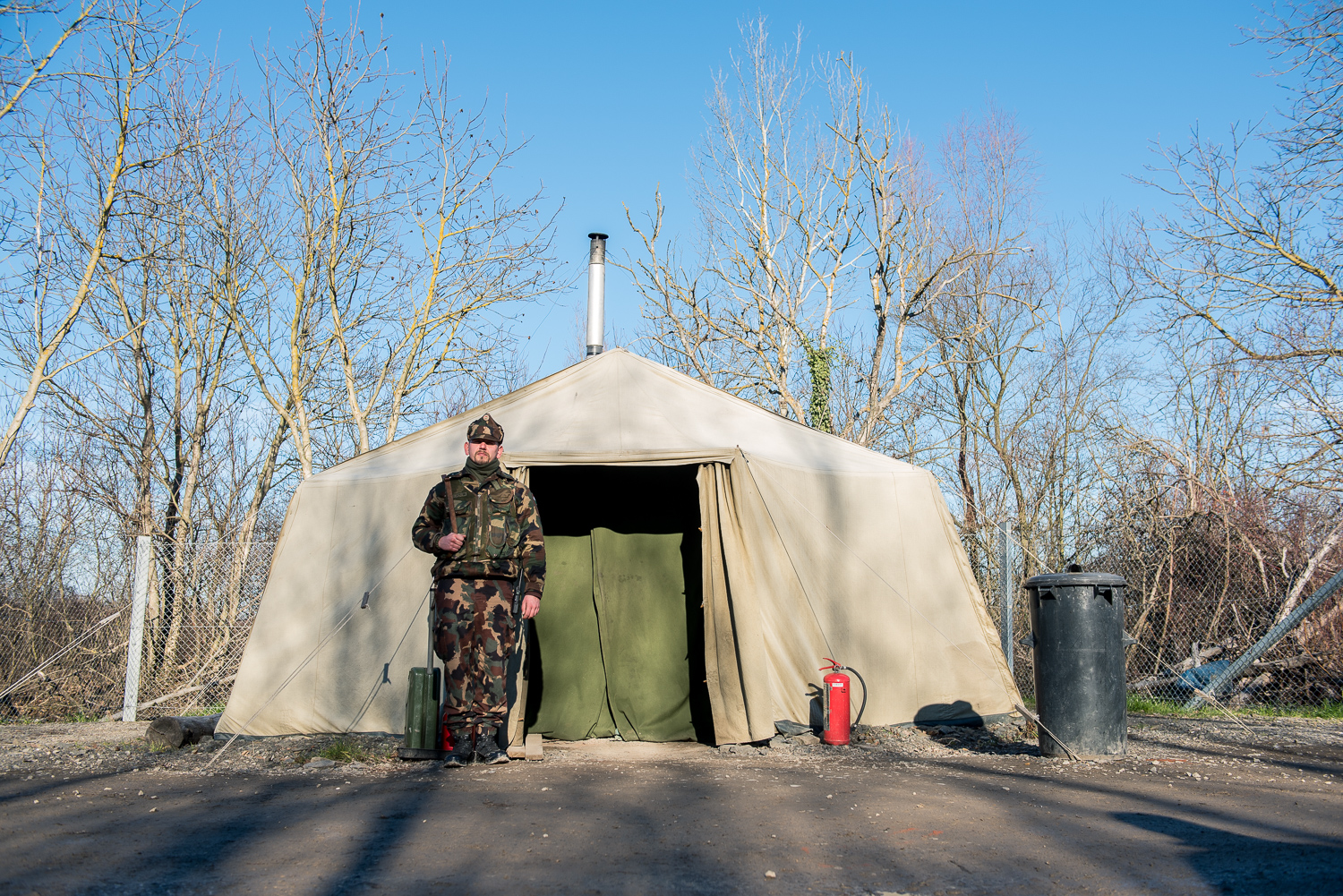  Soldier stands in front of a military warming tent to secure the border between Hungary and Serbia near Hercegszántó Hungary 24 December 2017. The Hungarian border fence was constructed in the middle of the European migration crisis in 2015, with th