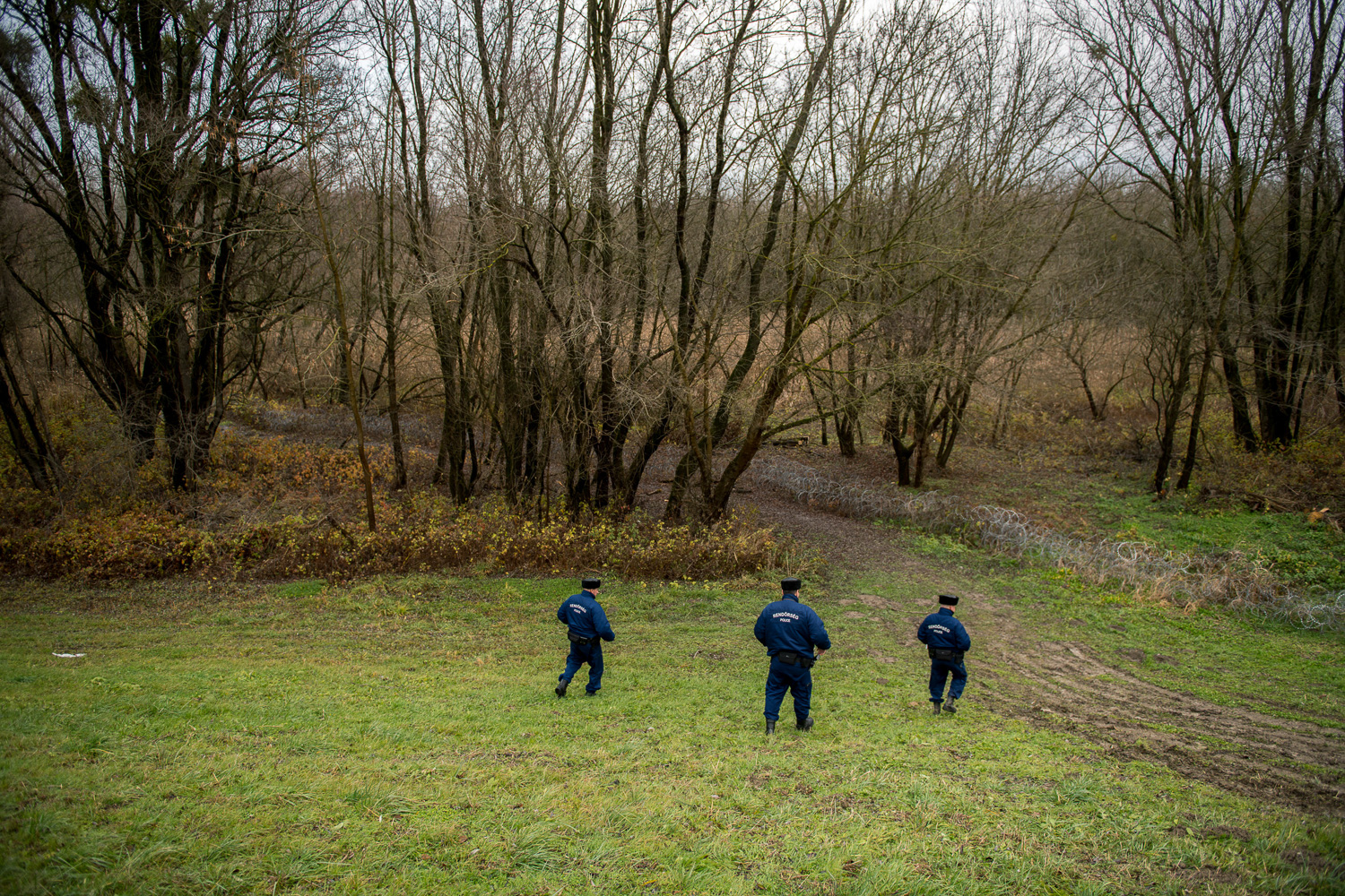  Policemen patroling near the barbed wire fence in the flood basin of Danube near Kölked, Hungary 9 December 2017. The fence was constructed in the middle of the European migration crisis in 2015, with the aim to ensure border security by preventing 