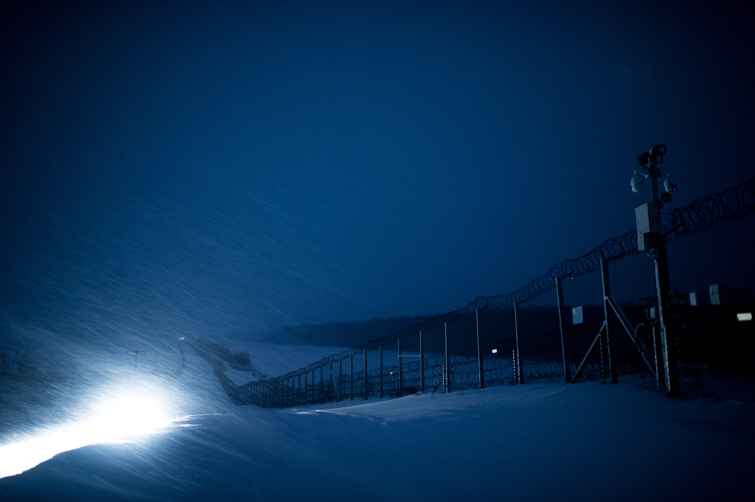  Military vehicle lights the snowfall between the two fences between Hungary and Serbia at Hercegszántó 27 February 2018. The fence was constructed in the middle of the European migration crisis in 2015, with the aim to ensure border security by prev