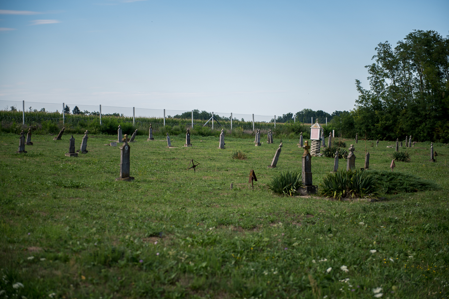  A cemetery in front of the Hungarian border barrier at the border between Hungary and Croatia at Luc, Croatia, 30 July 2017. The fence was constructed in the middle of the European migration crisis in 2015, with the aim to ensure border security by 