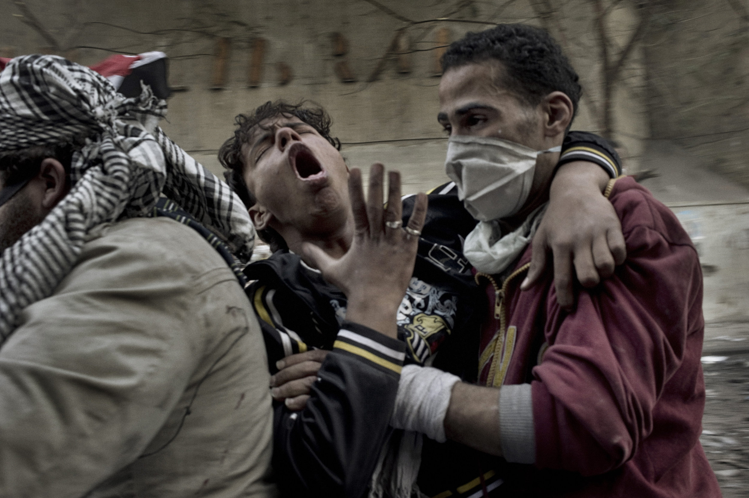   Cairo  Egypt  November 23, 2011: A protester overcome by tear gas is evacuated from Mohamed Mahmoud street, November 23, 2011.
 