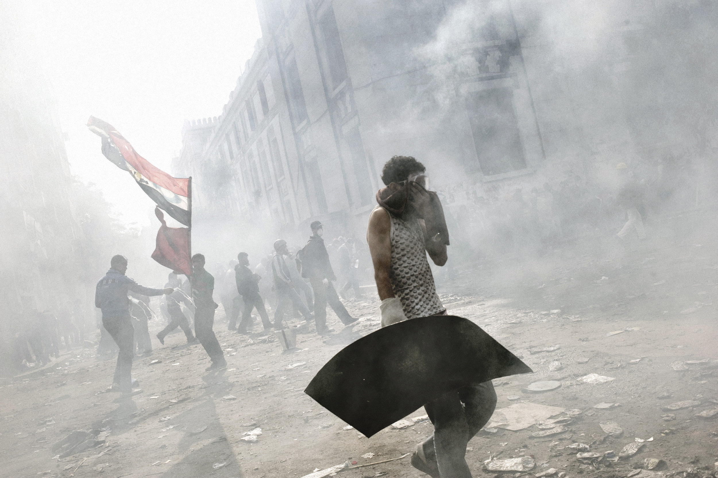 Cairo  Egypt  November 23, 2011: Tear gas fired by Egyptian security forces blankets a group of protesters, November 23, 2011.

 