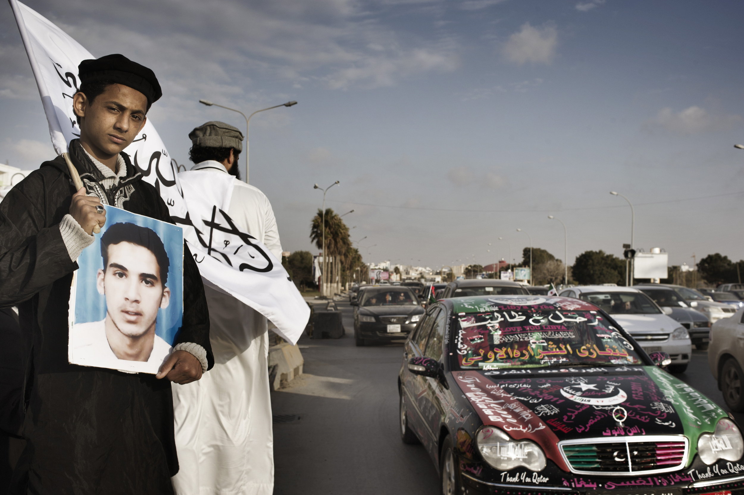  Benghazi Libya  March  26 2012: 
Dozens of Libyans protest along one of Benghazi?s main highways. The success of the revolution has yielded an atmosphere of free speech and freedom of protest?both new rights that Libyans have embraced wholeheartedly