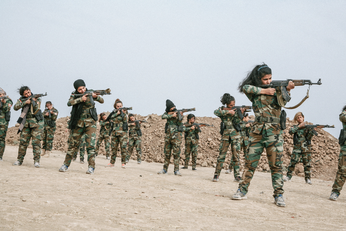  The young girls from PAK are training 6 km from Mosul, they feel happy that they are embodying the image of the strong and independent soldier who has been sold to them, they will not go to the fight. Bashiqa, Iraq, October 2016. 