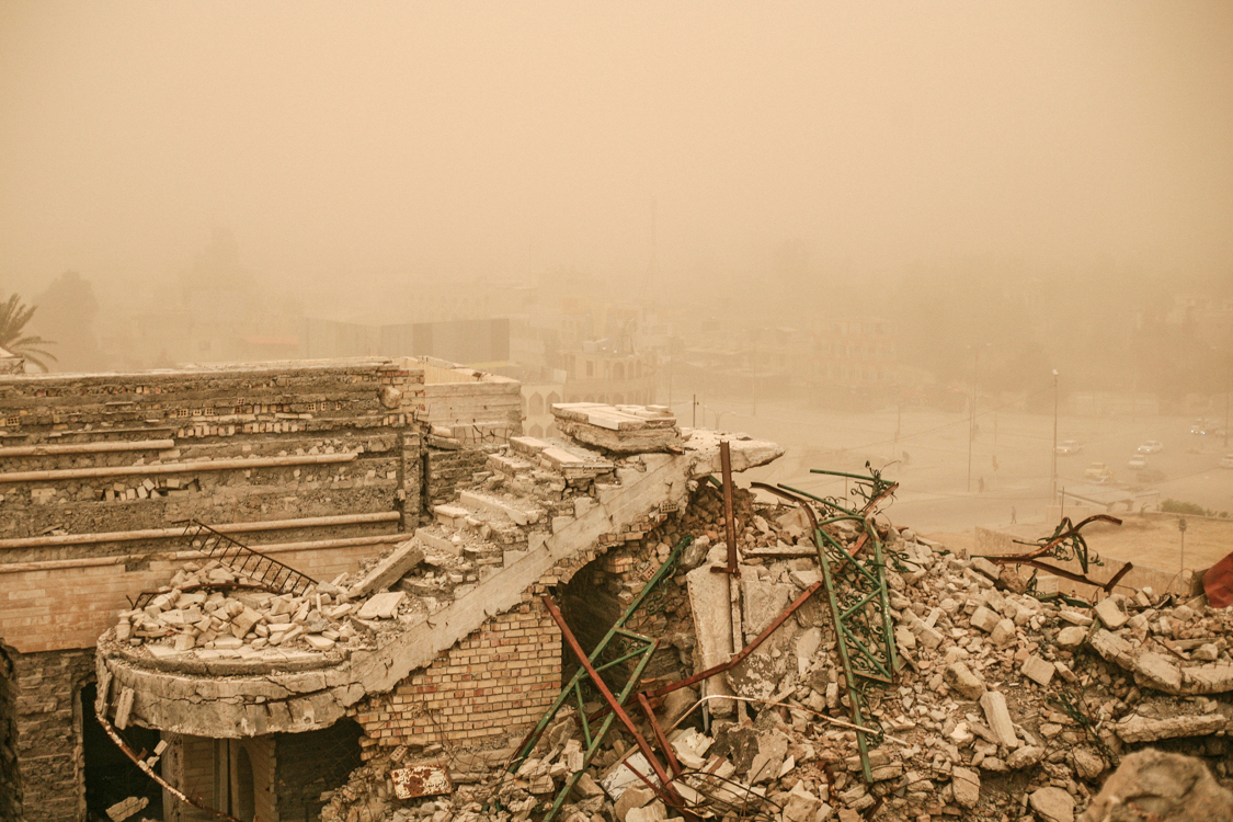  Sandstorm on the ruins of the city with dust. Mosul, Iraq, May 2017. 