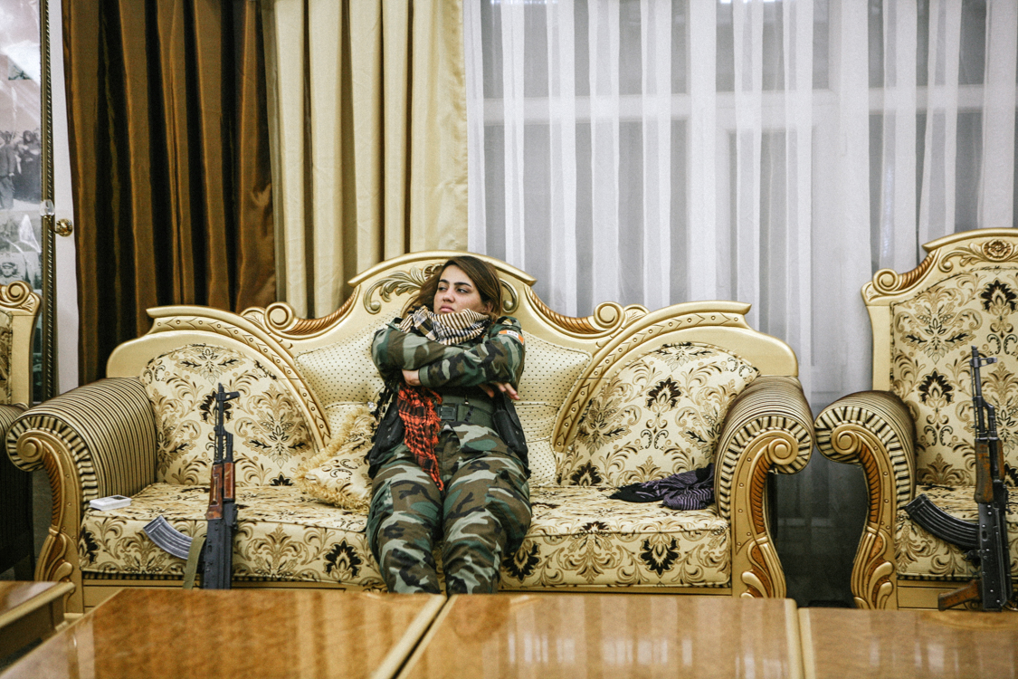  In a baroque room of the PAK headquarters, the young fighter Mani is getting bored. In one hour, she will be on the road to the Mosul offensive. Erbil, Iraq, October 2016. 