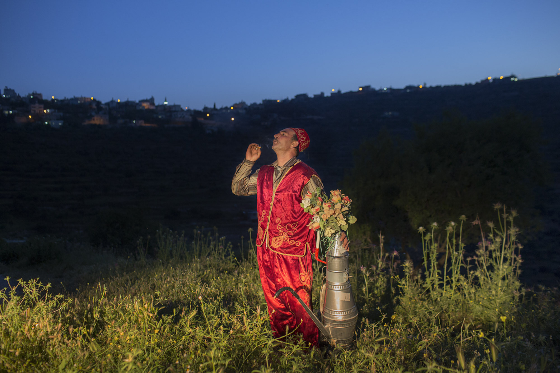  Occupied Palestinian Territories, West Bank, Abwein, 29 May 2015

A coffee seller in traditional dress takes a break for a smoke, in Abwein on the West Bank. 