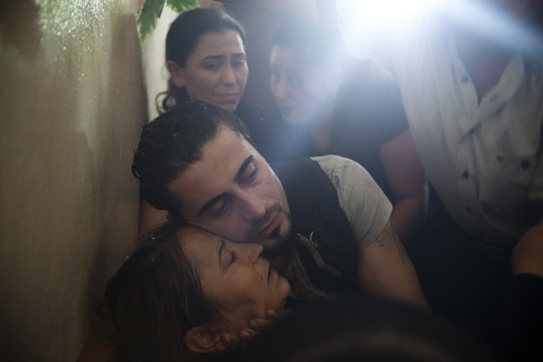  Bassel Barhoum hugs his mother Jamila Marshid during his brother's funeral in the village of Daqaqa in Latakia Province, Syria. Abu Layth died while fighting for the Syrian Army. 

Andrea Bruce/ For the NYTimes
30148013A 